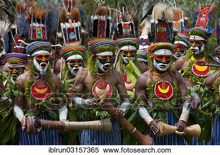 Stock Photography - "Men in colourfully decorated costumes with face paint are celebrating at the traditional Sing Sing gathering in the highlands, Paya, Papua New Guinea, Oceania". Fotosearch
