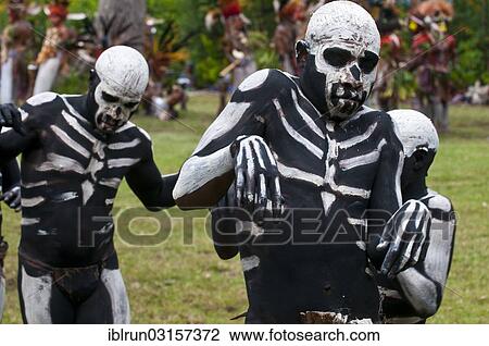 Stock Image - "Men with skeleton body paint are celebrating at the traditional Sing Sing gathering in the highlands, Paya, Papua New Guinea, Oceania". Fotosearch