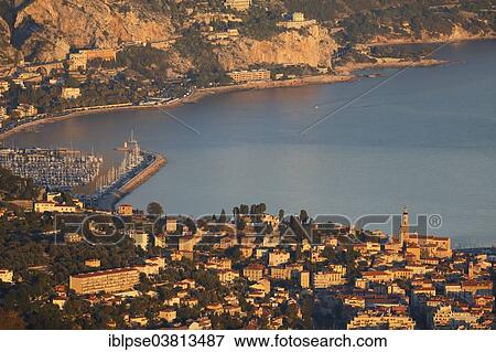 "Menton with the port of Garavan and the border to Italy in the evening light, seen from Mont Gros, Roquebrune Cap Martin, Alpes-Maritimes, Provence-Alpes-Cote d'Azur, France, Europe" View Large Photo Image Stock Photo - "Menton with the port of Garavan and the border to Italy in the evening light, seen from Mont Gros, Roquebrune Cap Martin, Alpes-Maritimes, Provence-Alpes-Cote d'Azur, France, Europe". Fotosearch