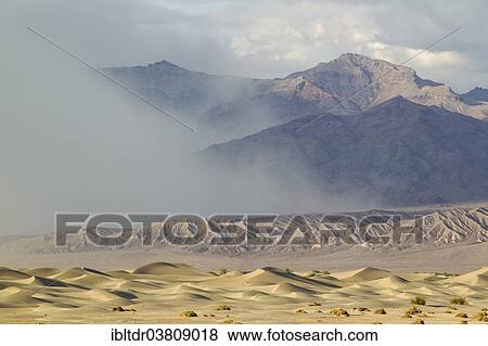"Mesquite Flat Sand Dunes, a sand storm over the Grapevine Mountains in the back, Death Valley, Death Valley National Park, California, USA" View Large Photo Image Stock Photo - "Mesquite Flat Sand Dunes, a sand storm over the Grapevine Mountains in the back, Death Valley, Death Valley National Park, California, USA". Fotosearch