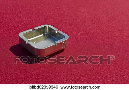 Metal ashtray on a red table cloth View Large Photo Image Stock Photograph - Metal ashtray on a red table cloth. Fotosearch