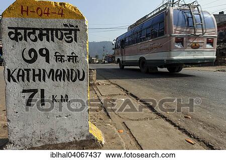 "Milestone at the roadside with a Nepalese bus passing, Patauri, Nepal, Asia" View Large Photo Image Stock Photo - "Milestone at the roadside with a Nepalese bus passing, Patauri, Nepal, Asia". Fotosearch