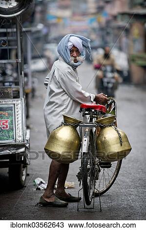 Stock Image - "Milk seller with a turban and a bicycle, Bundi, Rajasthan, India, Asia". Fotosearch