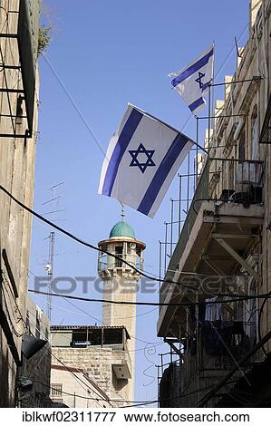 "Minaret in the Muslim Quarter, with Israeli flags as a protest against Jews moving into the quarter driving out the Palestinian inhabitants, Old City, Jerusalem, Israel, Middle East, Southwest Asia, Asia" View Large Photo Image Stock Photo - "Minaret in the Muslim Quarter, with Israeli flags as a protest against Jews moving into the quarter driving out the Palestinian inhabitants, Old City, Jerusalem, Israel, Middle East, Southwest Asia, Asia". Fotosearch