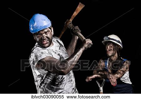 Stock Photography - "Miner holding a pick with a female miner behind him, Innsbruck, Tyrol, Austria, Europe". Fotosearch
