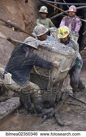 Stock Photograph - "Miners pushing a trolley at Cerro Rico, rich mountain, Potosi, Bolivia, South America". Fotosearch
