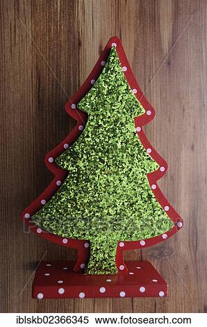 Miniature Christmas tree on a wooden surface View Large Photo Image Stock Photography - Miniature Christmas tree on a wooden surface. Fotosearch