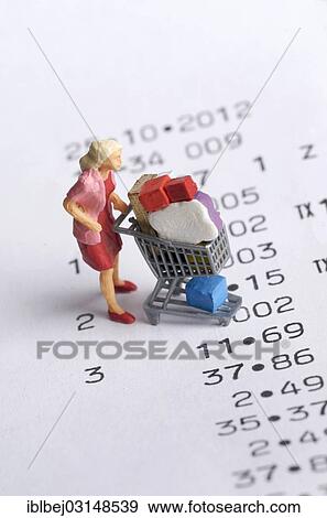 Stock Photo - "Miniature figurine of a woman with a shopping chart on a receipt, symbolic image for consumption, France, Europe". Fotosearch