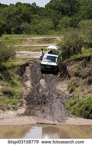 Stock Photo - "Minibus stuck in mud, Masai Mara, Rift Valley Province, Kenya, Africa". Fotosearch
