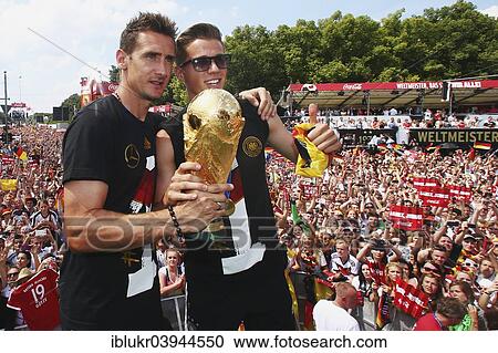 "Miroslav Klose and Erik Durm with the trophy, reception of the German national team after their victory at the FIFA World Cup 2014, fan party at the Brandenburg Gate, Berlin, Germany, Europe" View Large Photo Image Stock Image - "Miroslav Klose and Erik Durm with the trophy, reception of the German national team after their victory at the FIFA World Cup 2014, fan party at the Brandenburg Gate, Berlin, Germany, Europe". Fotosearch