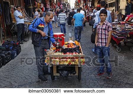 Stock Image - "Mobile juice sellers with pomegranates and oranges, bazaar district, Eminonu, Istanbul, European side, Istanbul Province, Turkey, European side, Europe". Fotosearch