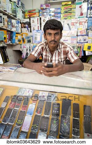 "Mobile phone seller in his shop, Madurai, Tamil Nadu, India, Asia" View Large Photo Image Stock Photo - "Mobile phone seller in his shop, Madurai, Tamil Nadu, India, Asia". Fotosearch