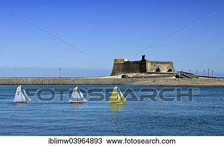 "Model sailing boats in a regatta in front of the fort Castillo de San Gabriel, Arrecife, Lanzarote, Canary Islands, Spain, Europe" View Large Photo Image Stock Image - "Model sailing boats in a regatta in front of the fort Castillo de San Gabriel, Arrecife, Lanzarote, Canary Islands, Spain, Europe". Fotosearch