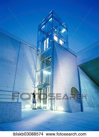 "Modern glass lift, evening, Messe Munchen, Munich, Upper Bavaria, Bavaria, Germany, Europe" View Large Photo Image Picture - "Modern glass lift, evening, Messe Munchen, Munich, Upper Bavaria, Bavaria, Germany, Europe". Fotosearch