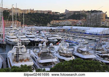 Stock Photography - "Monaco Yacht Show 2012, Port Hercule in the evening, Prince's Palace at the rear, Principality of Monaco, Cote d'Azur, Mediterranean Sea, Europe". Fotosearch