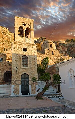 "Monemvasia, main square of the lower town with the bell tower of the Byzantine Greek Orthodox Church of Christ Elkomenos, Peloponnese, Greece, Europe" View Large Photo Image Stock Photo - "Monemvasia, main square of the lower town with the bell tower of the Byzantine Greek Orthodox Church of Christ Elkomenos, Peloponnese, Greece, Europe". Fotosearch