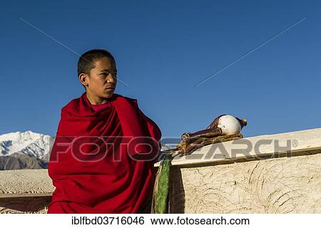 "Monk on the roof of Thiksey Gompa monastery, Ladakh, Jammu and Kashmir, India, Asia" View Large Photo Image Stock Photograph - "Monk on the roof of Thiksey Gompa monastery, Ladakh, Jammu and Kashmir, India, Asia". Fotosearch