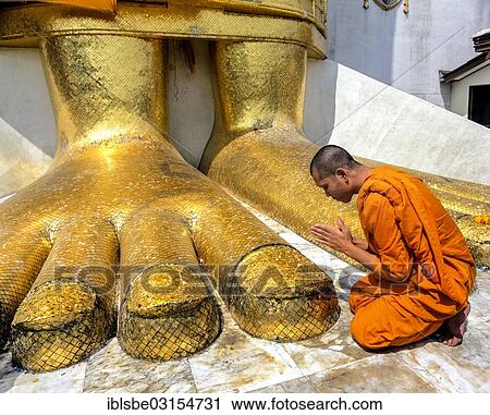 "Monk praying at the feet of the golden Buddha statue of Wat Intharawihan, Wat Indra, Bangkok, Central Thailand, Thailand, Asia" View Large Photo Image Stock Image - "Monk praying at the feet of the golden Buddha statue of Wat Intharawihan, Wat Indra, Bangkok, Central Thailand, Thailand, Asia". Fotosearch