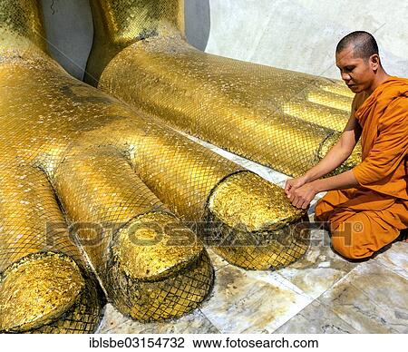"Monk praying at the feet of the golden Buddha statue of Wat Intharawihan, Wat Indra, Bangkok, Central Thailand, Thailand, Asia" View Large Photo Image Stock Image - "Monk praying at the feet of the golden Buddha statue of Wat Intharawihan, Wat Indra, Bangkok, Central Thailand, Thailand, Asia". Fotosearch