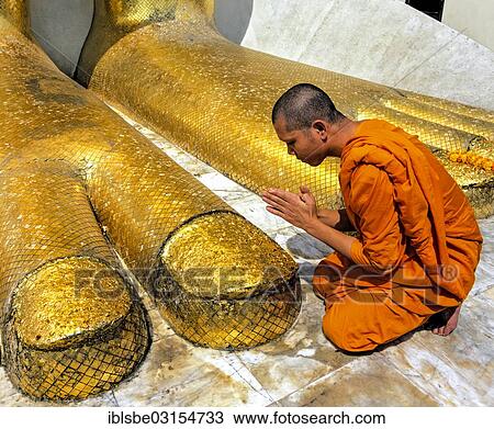 "Monk praying at the feet of the golden Buddha statue of Wat Intharawihan, Wat Indra, Bangkok, Central Thailand, Thailand, Asia" View Large Photo Image Stock Image - "Monk praying at the feet of the golden Buddha statue of Wat Intharawihan, Wat Indra, Bangkok, Central Thailand, Thailand, Asia". Fotosearch