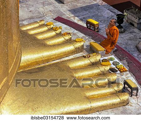 "Monk praying at the feet of the golden Buddha statue of Wat Intharawihan, Wat Indra, Bangkok, Central Thailand, Thailand, Asia" View Large Photo Image Stock Photo - "Monk praying at the feet of the golden Buddha statue of Wat Intharawihan, Wat Indra, Bangkok, Central Thailand, Thailand, Asia". Fotosearch