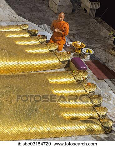 "Monk praying at the feet of the golden Buddha statue of Wat Intharawihan, Wat Indra, Bangkok, Central Thailand, Thailand, Asia" View Large Photo Image Stock Photo - "Monk praying at the feet of the golden Buddha statue of Wat Intharawihan, Wat Indra, Bangkok, Central Thailand, Thailand, Asia". Fotosearch