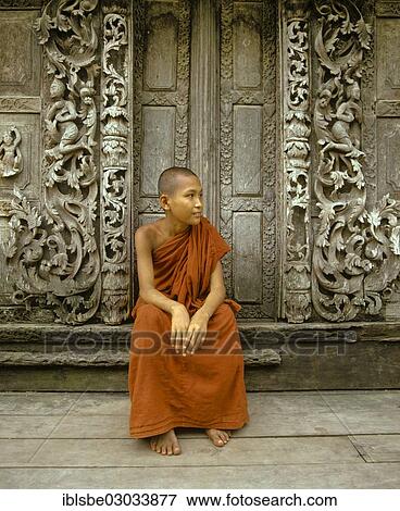 "Monk sitting in front of a wooden door with teak carvings, Shwe In Bin Kyaung Monastery, Mandalay, Mandalay Division, Myanmar, Burma, Asia" View Large Photo Image Stock Photo - "Monk sitting in front of a wooden door with teak carvings, Shwe In Bin Kyaung Monastery, Mandalay, Mandalay Division, Myanmar, Burma, Asia". Fotosearch