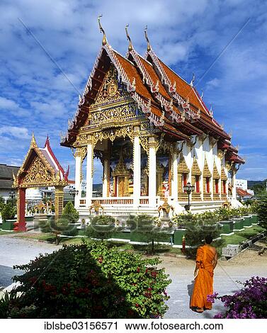 Stock Image - "Monk standing in front of Wat Phra Nang Sang, a Buddhist temple, Phuket, Phuket Province, Thailand, Asia". Fotosearch