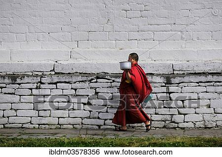 "Monk walking through the monastery courtyard in Jampey Lhakhang Temple, Jakar, Bumthang district, Bhutan, Asia" View Large Photo Image Stock Photograph - "Monk walking through the monastery courtyard in Jampey Lhakhang Temple, Jakar, Bumthang district, Bhutan, Asia". Fotosearch