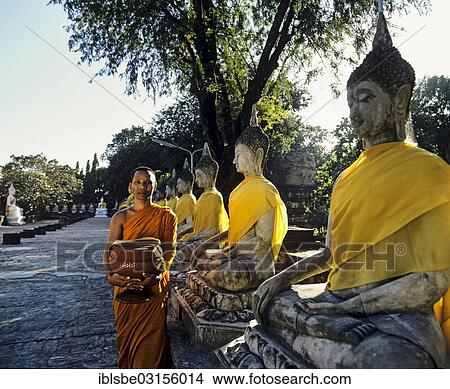 "Monk with a begging bowl standing next to seated Buddha statues in the gardens of the Wat Yai Chai Mongkon Temple, UNESCO World Heritage Site, Ayutthaya Historical Park, Ayutthaya, Ayutthaya province, Central Thailand, Thailand, Asia" View Large Photo Image Picture - "Monk with a begging bowl standing next to seated Buddha statues in the gardens of the Wat Yai Chai Mongkon Temple, UNESCO World Heritage Site, Ayutthaya Historical Park, Ayutthaya, Ayutthaya province, Central Thailand, Thailand, Asia". Fotosearch
