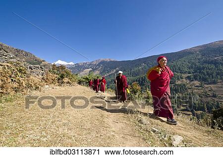 "Monks and nuns wearing red cloths walking on a small path along a mountain slope, Junbesi, Solukhumbu District, Sagarmatha Zone, Nepal, Asia" View Large Photo Image Stock Image - "Monks and nuns wearing red cloths walking on a small path along a mountain slope, Junbesi, Solukhumbu District, Sagarmatha Zone, Nepal, Asia". Fotosearch