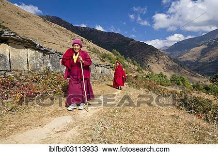 "Monks and nuns wearing red cloths walking on a small path along a mountain slope, Junbesi, Solukhumbu District, Sagarmatha Zone, Nepal, Asia" View Large Photo Image Stock Image - "Monks and nuns wearing red cloths walking on a small path along a mountain slope, Junbesi, Solukhumbu District, Sagarmatha Zone, Nepal, Asia". Fotosearch