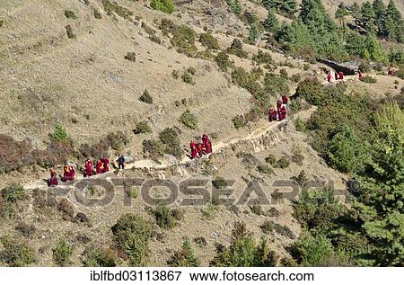 "Monks and nuns wearing red cloths walking on a small path along a mountain slope, Junbesi, Solukhumbu District, Sagarmatha Zone, Nepal, Asia" View Large Photo Image Stock Photo - "Monks and nuns wearing red cloths walking on a small path along a mountain slope, Junbesi, Solukhumbu District, Sagarmatha Zone, Nepal, Asia". Fotosearch
