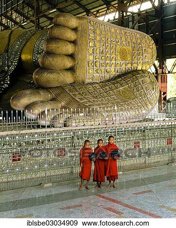 "Monks holding begging bowls standing in front of the feet of the Reclining Buddha of Chauk Htat Gyi, Rangun, Yangon Region, Myanmar, Burma, Asia" View Large Photo Image Stock Photo - "Monks holding begging bowls standing in front of the feet of the Reclining Buddha of Chauk Htat Gyi, Rangun, Yangon Region, Myanmar, Burma, Asia". Fotosearch