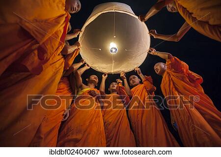 "Monks releasing a Kongming lantern or sky lantern for luck during the Loi Krathong or Loy Gratong Festival, Chiang Mai, Northern Thailand, Thailand, Asia" View Large Photo Image Stock Photo - "Monks releasing a Kongming lantern or sky lantern for luck during the Loi Krathong or Loy Gratong Festival, Chiang Mai, Northern Thailand, Thailand, Asia". Fotosearch