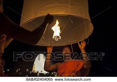 "Monks releasing a Kongming lantern or sky lantern for luck during the Loi Krathong or Loy Gratong Festival, Chiang Mai, Northern Thailand, Thailand, Asia" View Large Photo Image Stock Photography - "Monks releasing a Kongming lantern or sky lantern for luck during the Loi Krathong or Loy Gratong Festival, Chiang Mai, Northern Thailand, Thailand, Asia". Fotosearch