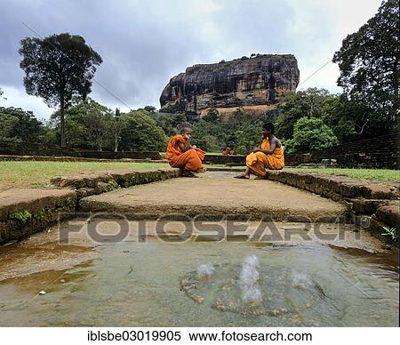 "Monks sitting at the cistern, spring at the Rock of Sigiriya, Lion Rock, column of rock of an eroded volcano, UNESCO World Heritage Site, Sigiriya, Sigirija, Zentralprovinz, Sri Lanka, Asia" View Large Photo Image Stock Photography - "Monks sitting at the cistern, spring at the Rock of Sigiriya, Lion Rock, column of rock of an eroded volcano, UNESCO World Heritage Site, Sigiriya, Sigirija, Zentralprovinz, Sri Lanka, Asia". Fotosearch