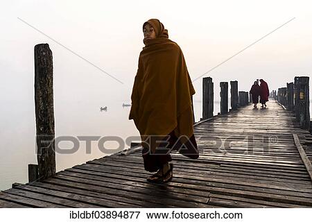"Monks walking on a teak bridge, U Bein Bridge, across Thaungthaman lake, in the morning, Amarapura, Mandalay Division, Myanmar, Asia" View Large Photo Image Stock Photo - "Monks walking on a teak bridge, U Bein Bridge, across Thaungthaman lake, in the morning, Amarapura, Mandalay Division, Myanmar, Asia". Fotosearch