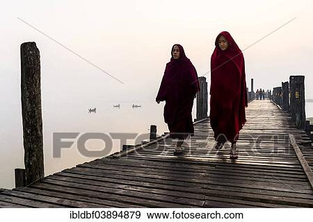 "Monks walking on a teak bridge, U Bein Bridge, across Thaungthaman lake, in the morning, Amarapura, Mandalay Division, Myanmar, Asia" View Large Photo Image Stock Photo - "Monks walking on a teak bridge, U Bein Bridge, across Thaungthaman lake, in the morning, Amarapura, Mandalay Division, Myanmar, Asia". Fotosearch
