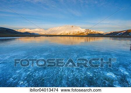 "Monte Vettore in the evening light with a frozen puddle with air bubbles, Monti Sibillini National Park, Umbria, Italy, Europe" View Large Photo Image Picture - "Monte Vettore in the evening light with a frozen puddle with air bubbles, Monti Sibillini National Park, Umbria, Italy, Europe". Fotosearch