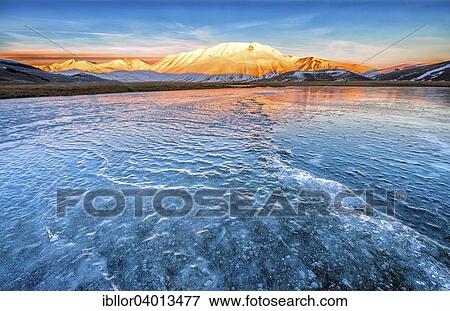 "Monte Vettore in the evening light with a frozen puddle with small waves, Monti Sibillini National Park, Umbria, Italy, Europe" View Large Photo Image Stock Photo - "Monte Vettore in the evening light with a frozen puddle with small waves, Monti Sibillini National Park, Umbria, Italy, Europe". Fotosearch