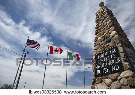 Stock Photo - "Monument to mark the geographical center of North America and the flags of the US, Canada, and Mexico, Rugby, North Dakota, United States, North America". Fotosearch