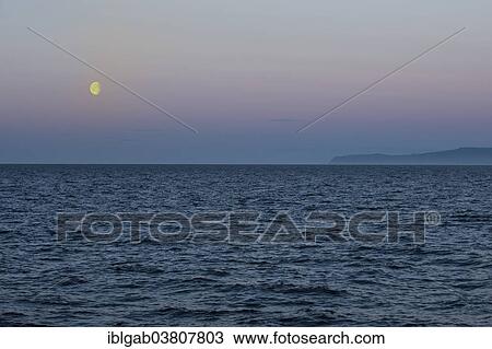 Stock Image - "Moon setting over the Bering Strait, Chukotka, Russia, Europe". Fotosearch
