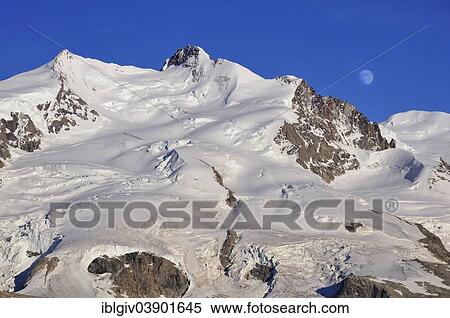 "Moonrise over Monte Rosa with Dufour Peak, 4638 m, Gornergrat Ridge, Zermatt, Canton of Valais, Switzerland, Europe" View Large Photo Image Stock Photography - "Moonrise over Monte Rosa with Dufour Peak, 4638 m, Gornergrat Ridge, Zermatt, Canton of Valais, Switzerland, Europe". Fotosearch
