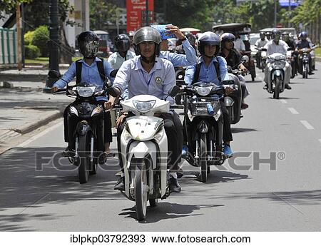 Stock Image - "Mopeds and scooters in traffic, Phnom Penh, Cambodia, Asia". Fotosearch