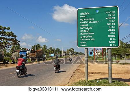Stock Image - "Mopeds travelling on the National Road No. 5, Pursat Province, Cambodia, Asia". Fotosearch