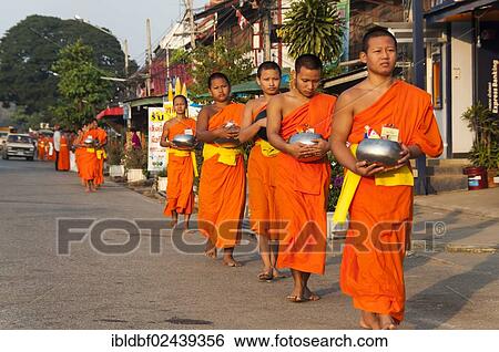 "Morning alms round, young Buddhist monks from a monastery school holding begging bowls, Sukhothai Province, Northern Thailand, Thailand, Asia" View Large Photo Image Stock Photograph - "Morning alms round, young Buddhist monks from a monastery school holding begging bowls, Sukhothai Province, Northern Thailand, Thailand, Asia". Fotosearch