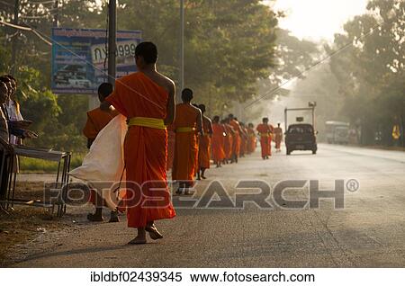 Stock Photography - "Morning alms round, young Buddhist monks from a monastery school, Sukhothai Province, Northern Thailand, Thailand, Asia". Fotosearch