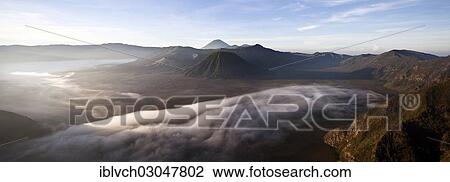 "Morning fog in the Tengger Caldera with Mount Bromo volcano, mid-left crater, Batok Volcano, middle, and Gunung Semeru volcano at the rear, Bromo Tengger Semeru National Park, Eastern Java, Java, Indonesia, Asia" View Large Photo Image Stock Image - "Morning fog in the Tengger Caldera with Mount Bromo volcano, mid-left crater, Batok Volcano, middle, and Gunung Semeru volcano at the rear, Bromo Tengger Semeru National Park, Eastern Java, Java, Indonesia, Asia". Fotosearch