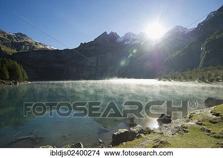 Picture - "Morning fog, Oeschinensee lake, Kandersteg, Bernese Oberland, Canton of Bern, Switzerland, Europe". Fotosearch